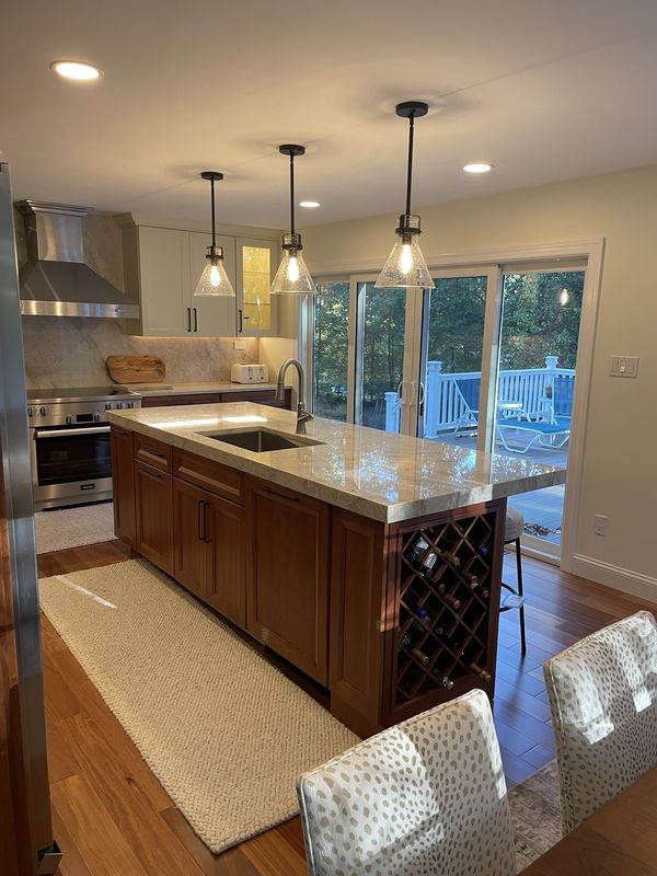 Island with built-in wine rack, the range wall and new sliding doors to the deck